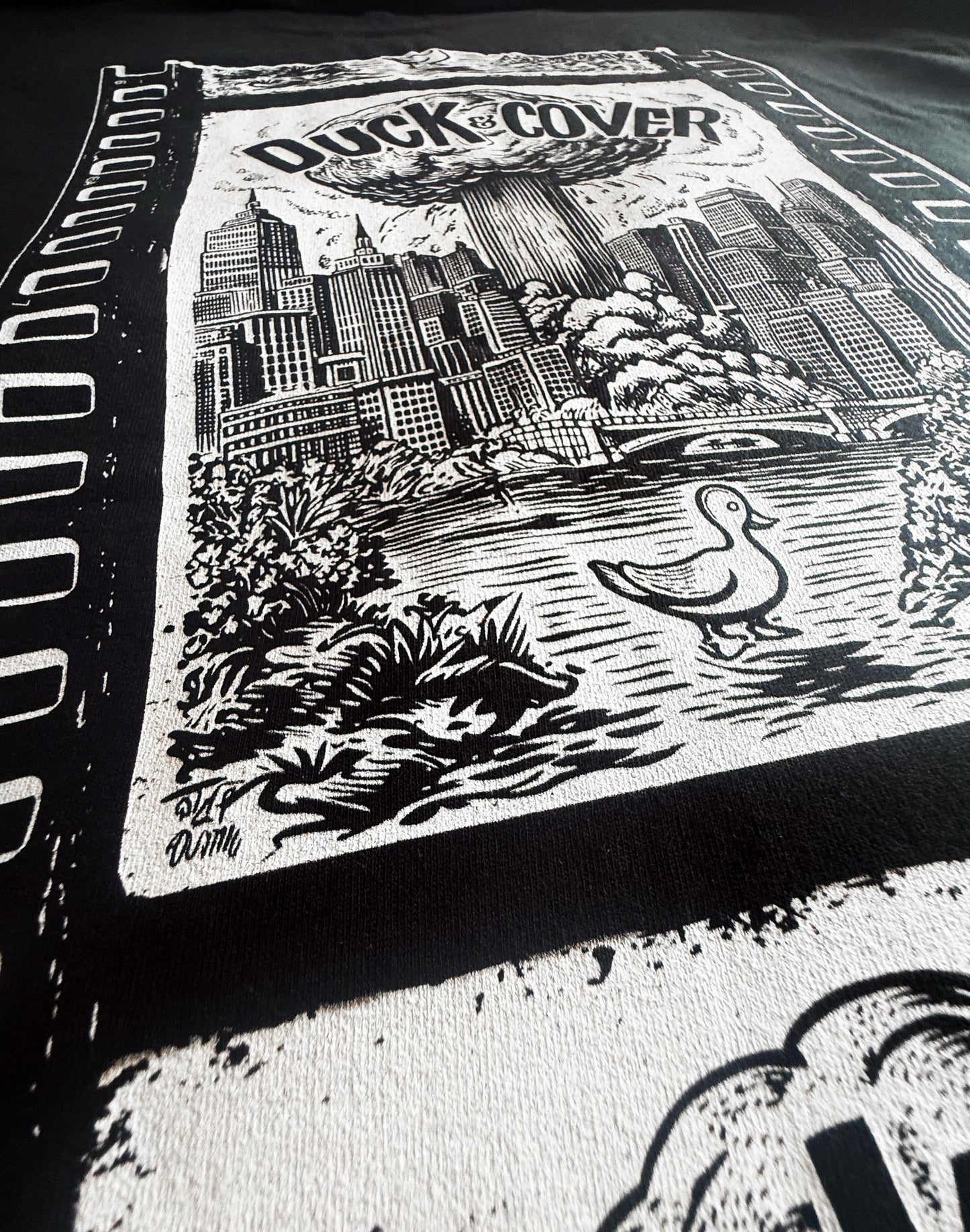 Black Unisex Premium Original Heavyweight Back-Design Tee "Duck & Cover" by Designer and Artist Lucas Gillon