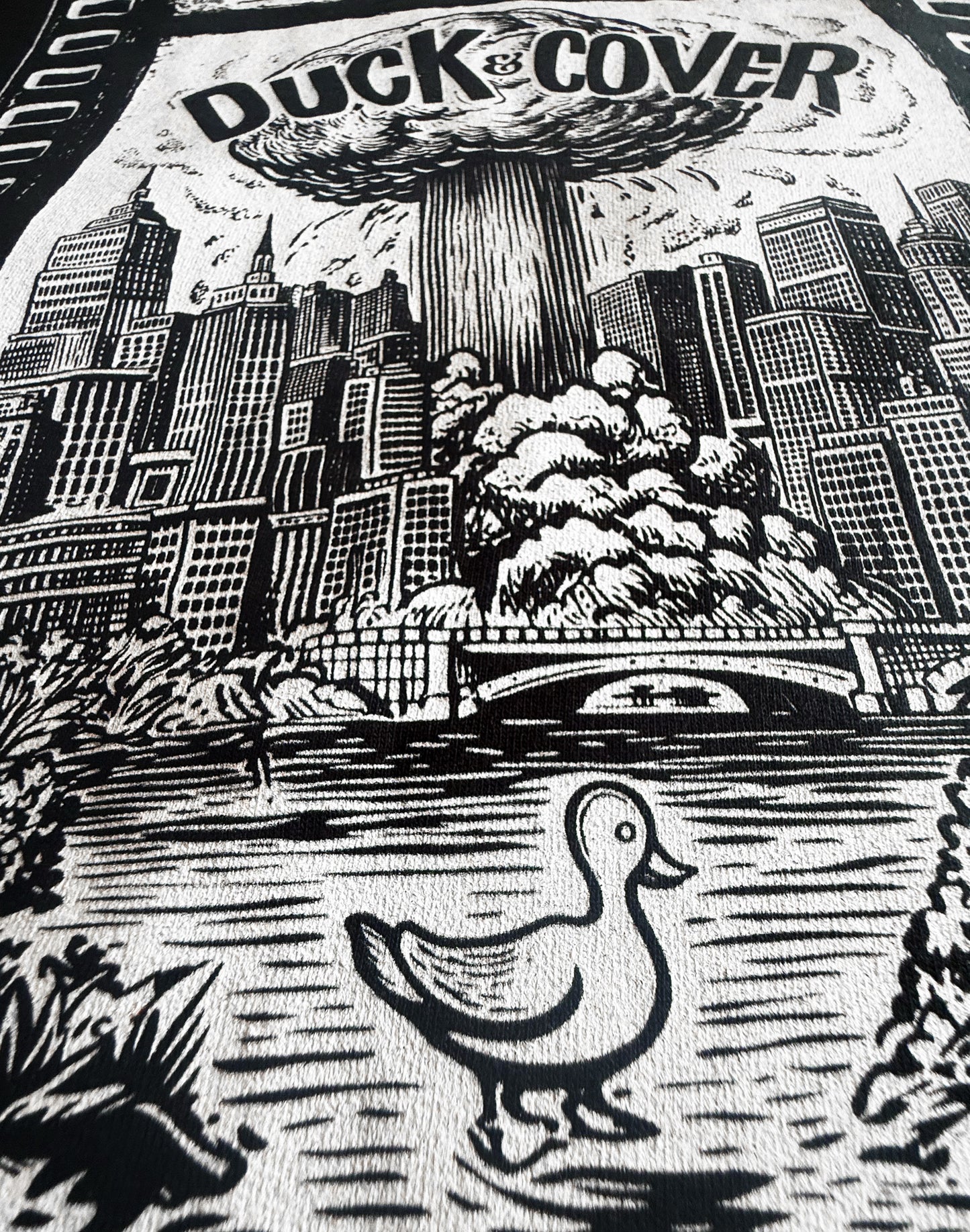Black Unisex Premium Original Heavyweight Back-Design Tee "Duck & Cover" by Designer and Artist Lucas Gillon